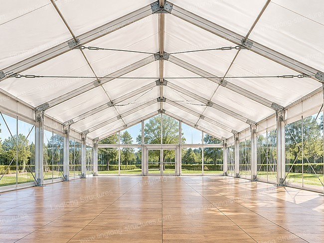 Clear glass wall wedding marquee on lawn for luxury outdoor wedding event