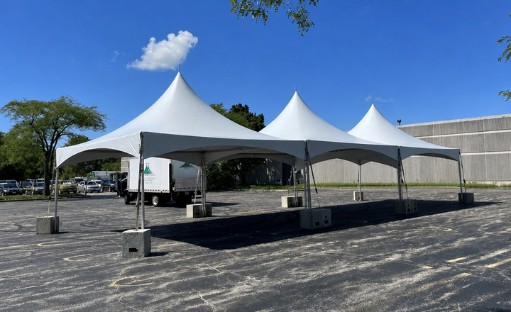 Outdoor shelter installed on grass for garden party and seasonal celebrations